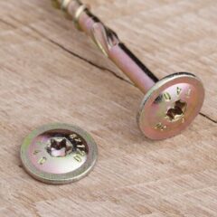 a screw and a screw on a wood surface