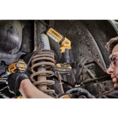 a man using a drill to drill a car
