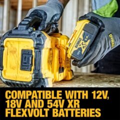 a person holding a yellow and black battery